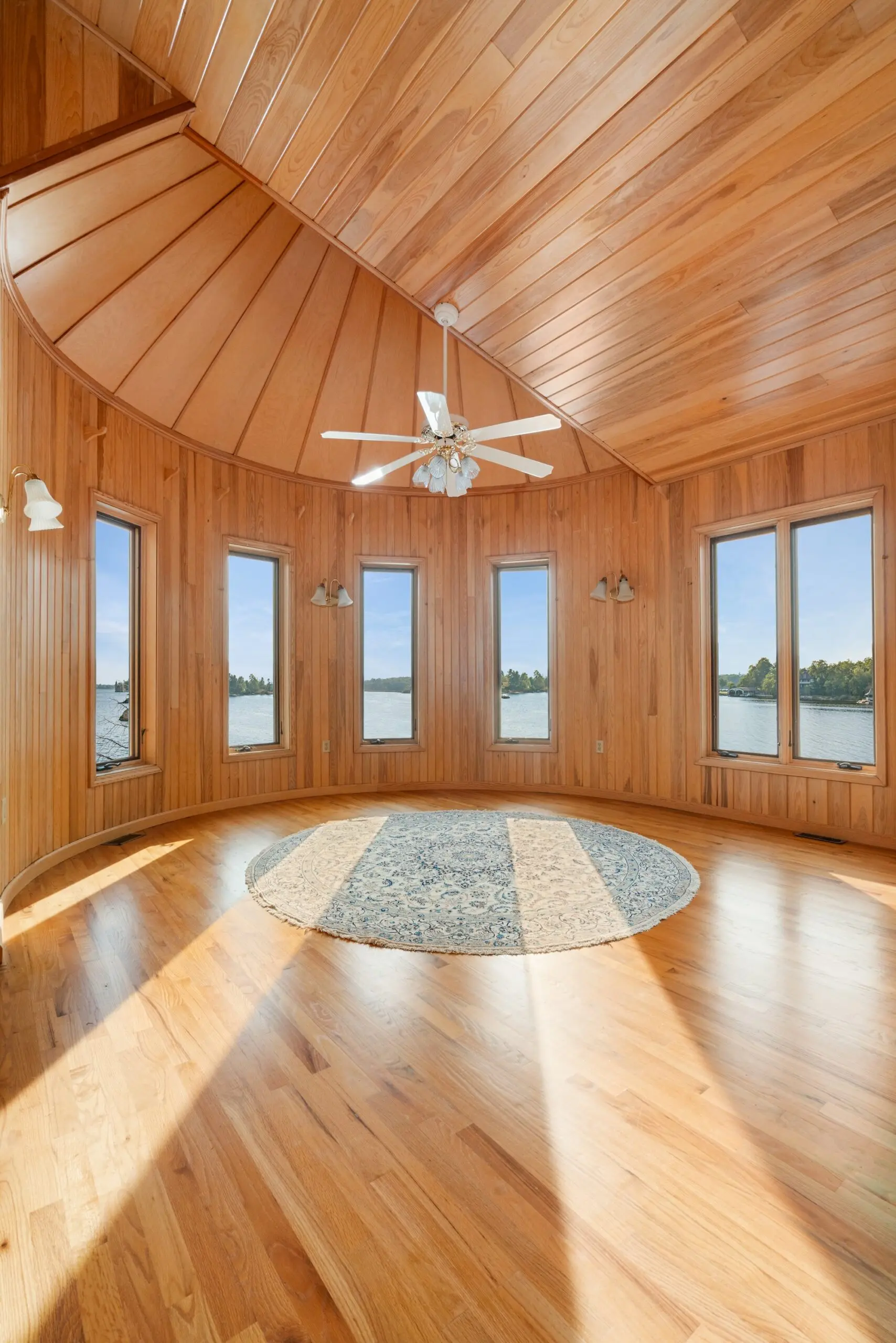 Interior of the Soil Room: a circular cedar-panelled chamber under a ribbed timber dome with a ring of tall windows