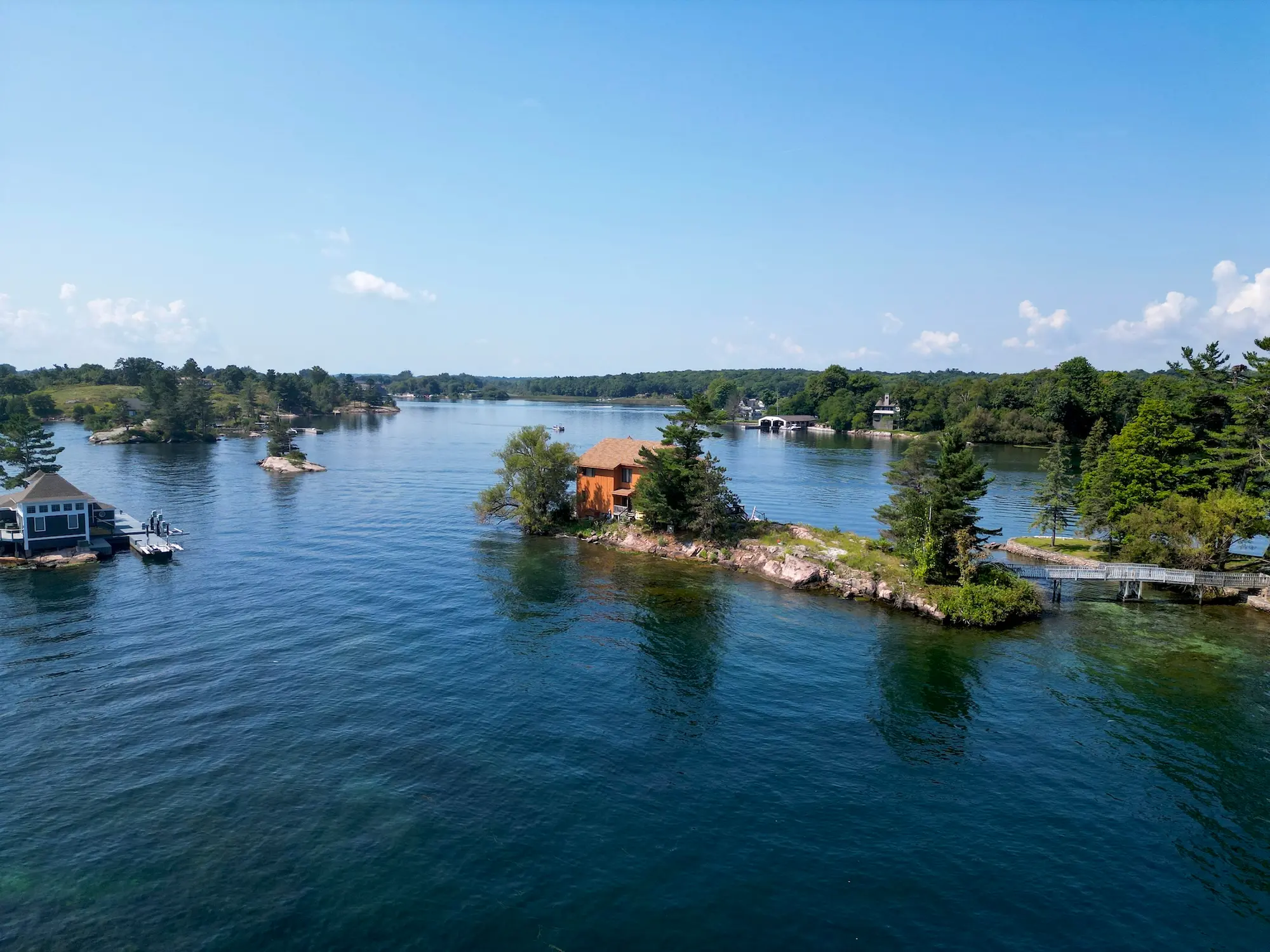 Aerial view of 1 St. Mary Isle showing the cedar house, boardwalk and jetty across the St. Lawrence River